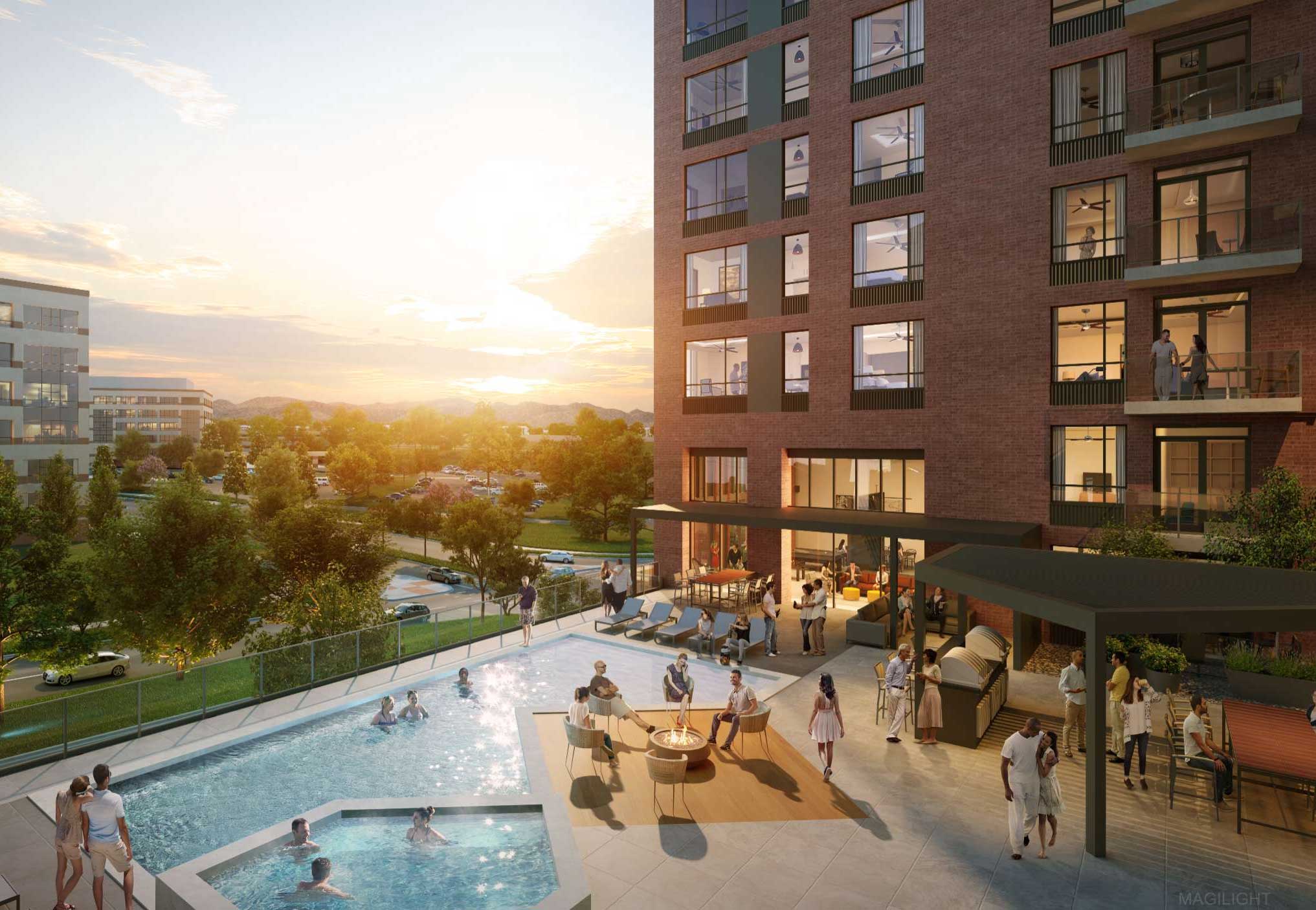 Apartment building with a pool area and people relaxing at sunset.