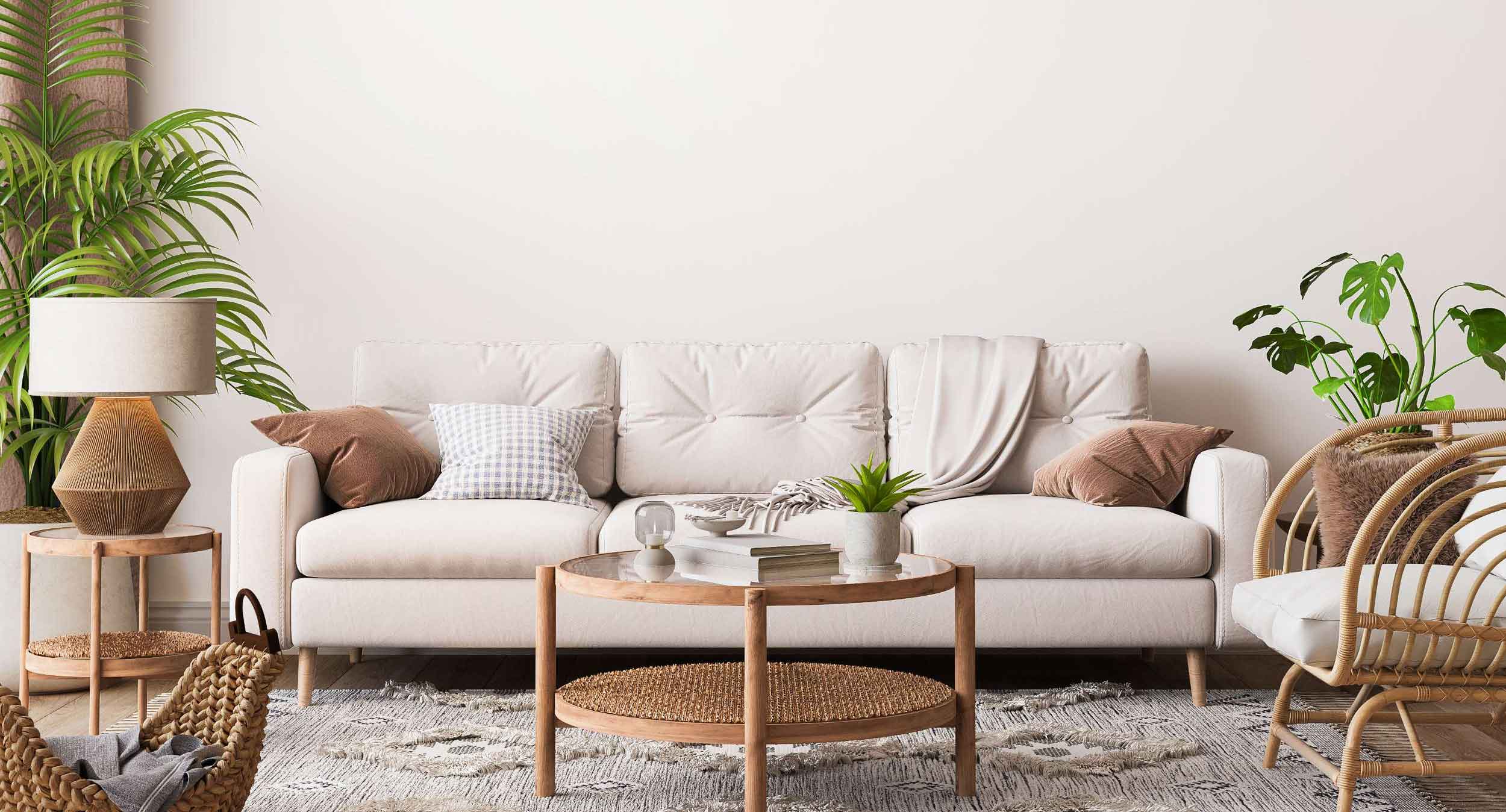 A cozy living room featuring a white wall and a comfortable couch, creating a serene and inviting atmosphere